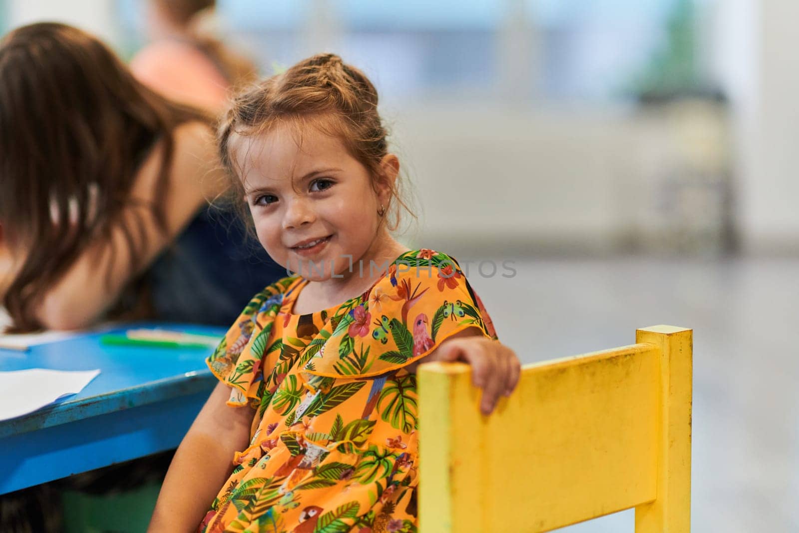 Creative kids sitting in a preschool institution, draw and have fun while they get an education. High quality photo