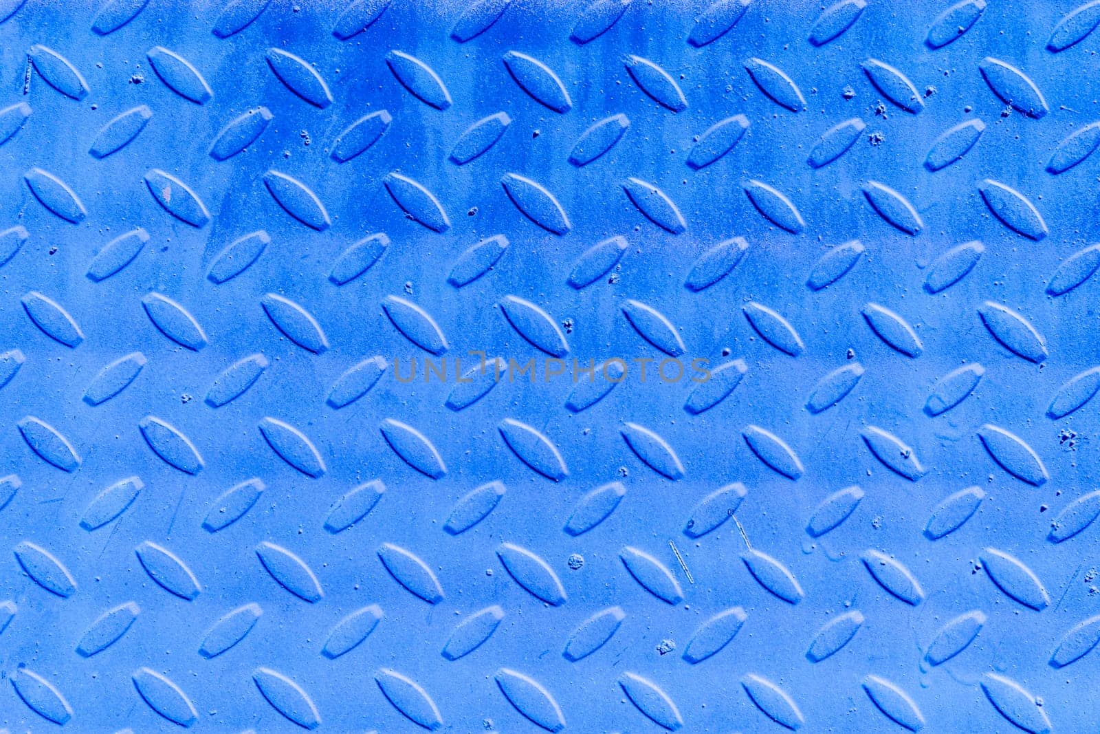 The background of the corrugated iron sheet is blue. Textured abstract blue background with copy space