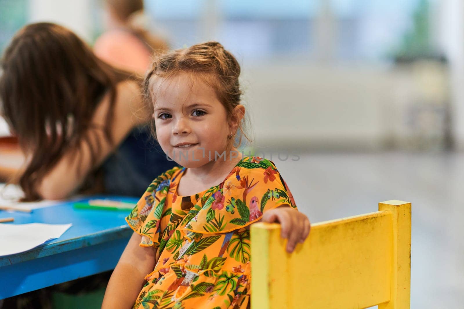 Creative kids sitting in a preschool institution, draw and have fun while they get an education. High quality photo