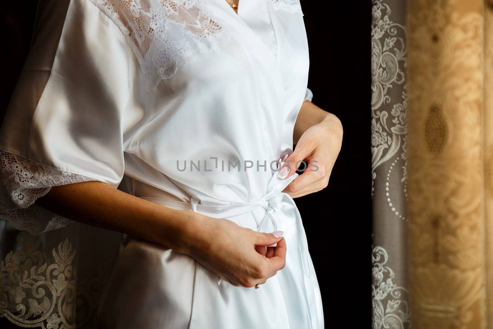 Beautiful bride in a white coat on a wedding day by Dmitrytph