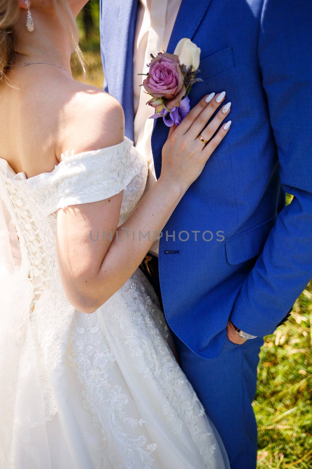 gold wedding rings in the hands of the newlyweds by Dmitrytph