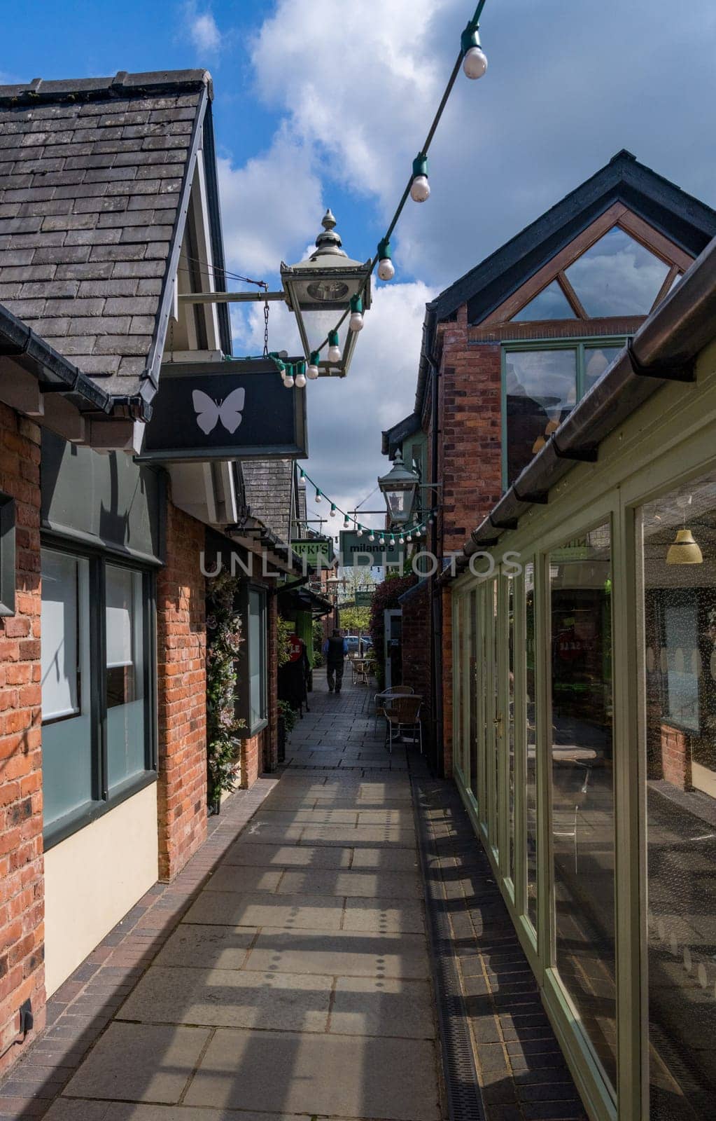 Oswestry, Shropshire - 12 May 2023: Shops and cafes along Old Chapel Court in market town of Oswestry