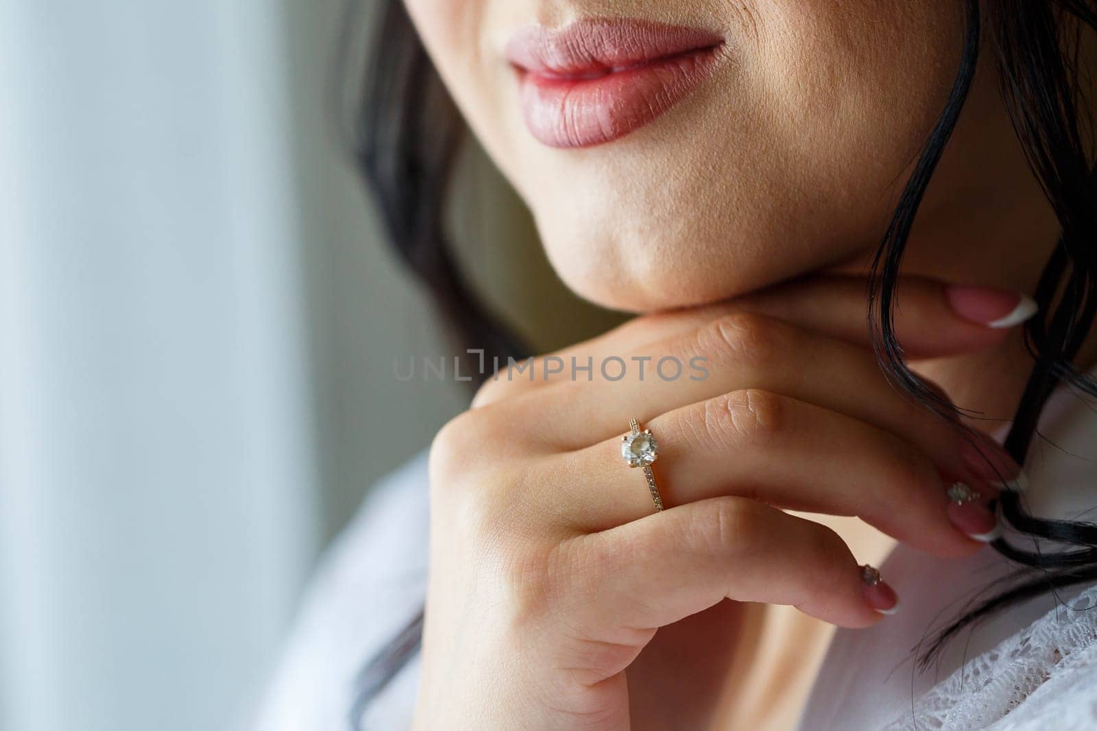 gold wedding rings in the hands of the newlyweds