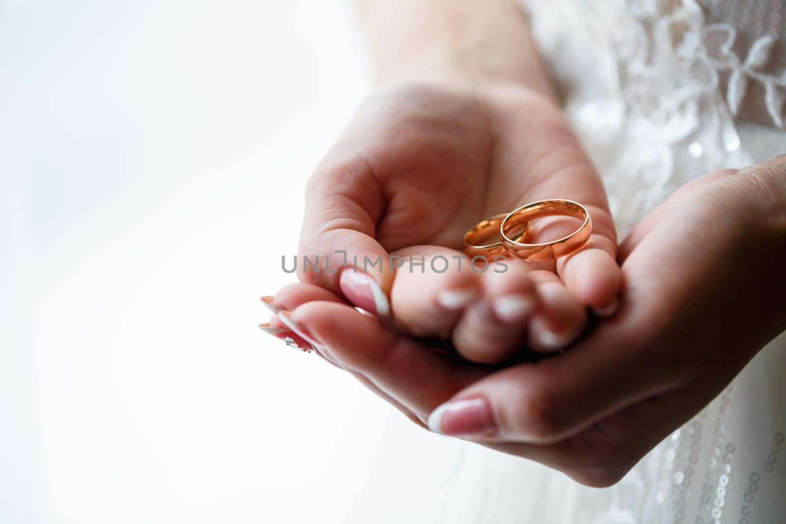 Golden wedding rings for newlyweds on their wedding day by Dmitrytph