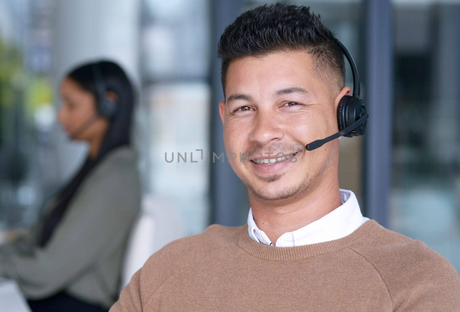 Man with smile in portrait, call center with CRM and contact us, communication with headset and technology in office. Male consultant, face with customer service or telemarketing with help desk job.
