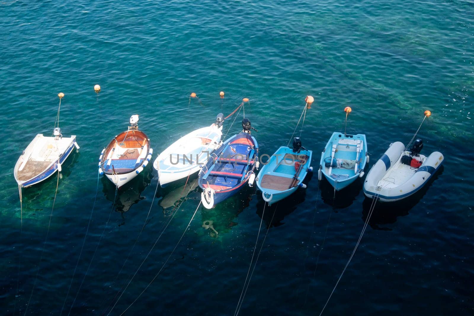 Photographic documentation of small fishing boats moored in port 