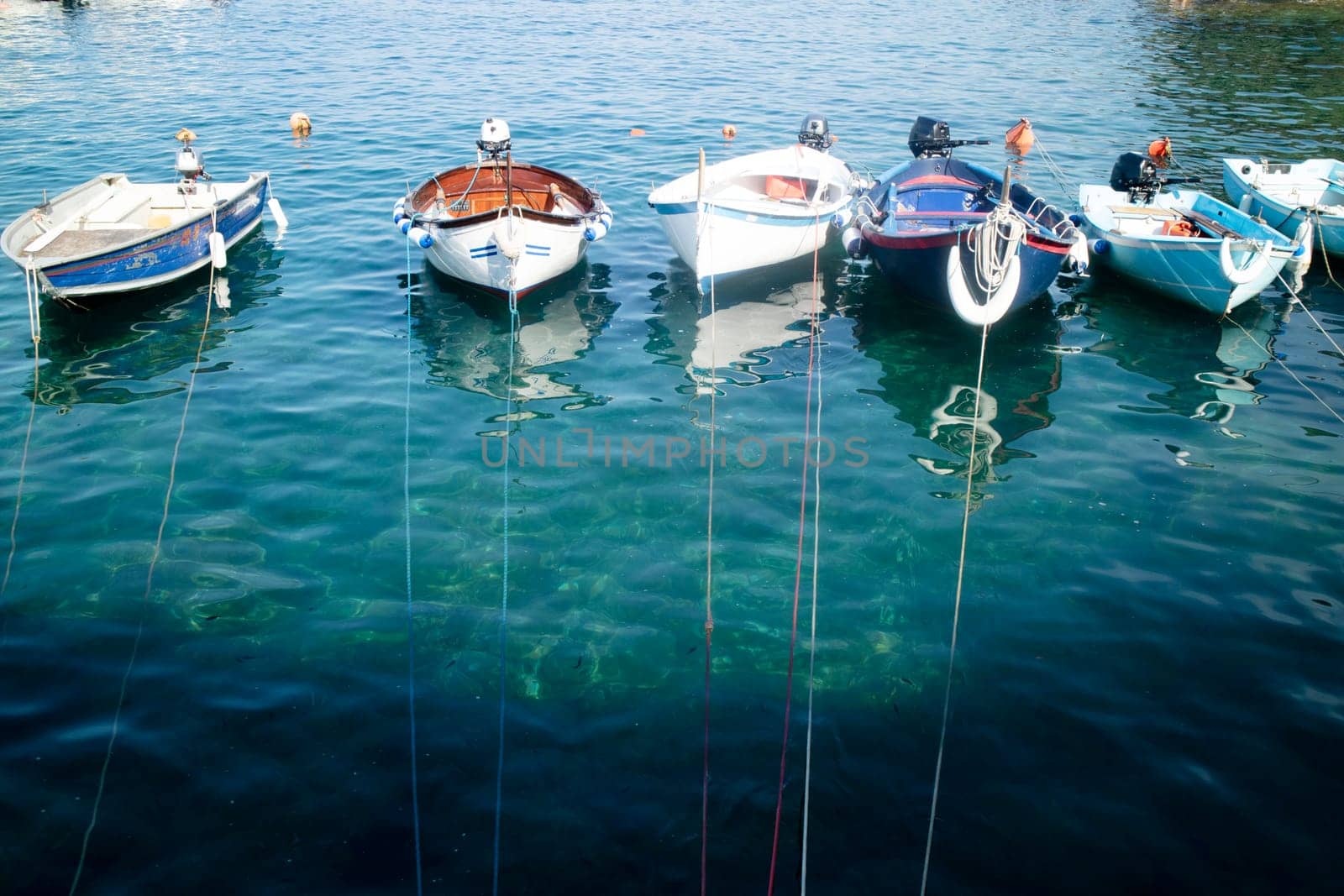 Photographic documentation of small fishing boats moored in port 