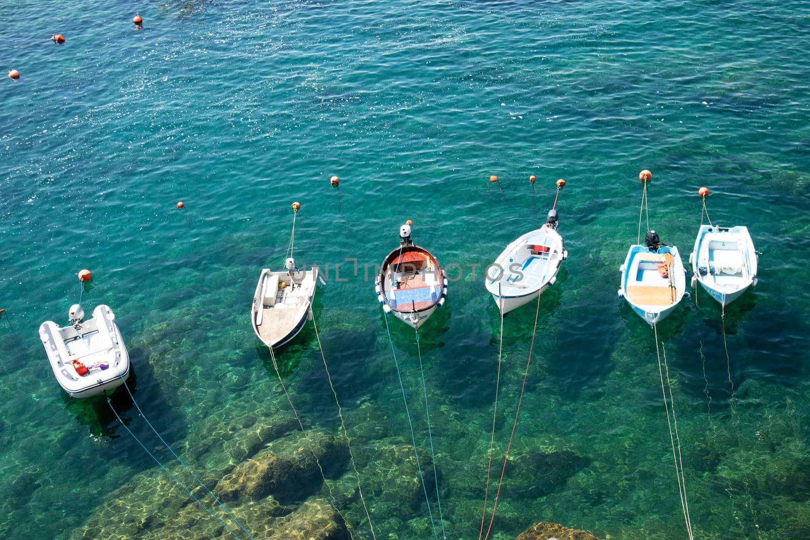 Photographic documentation of small fishing boats moored in port 