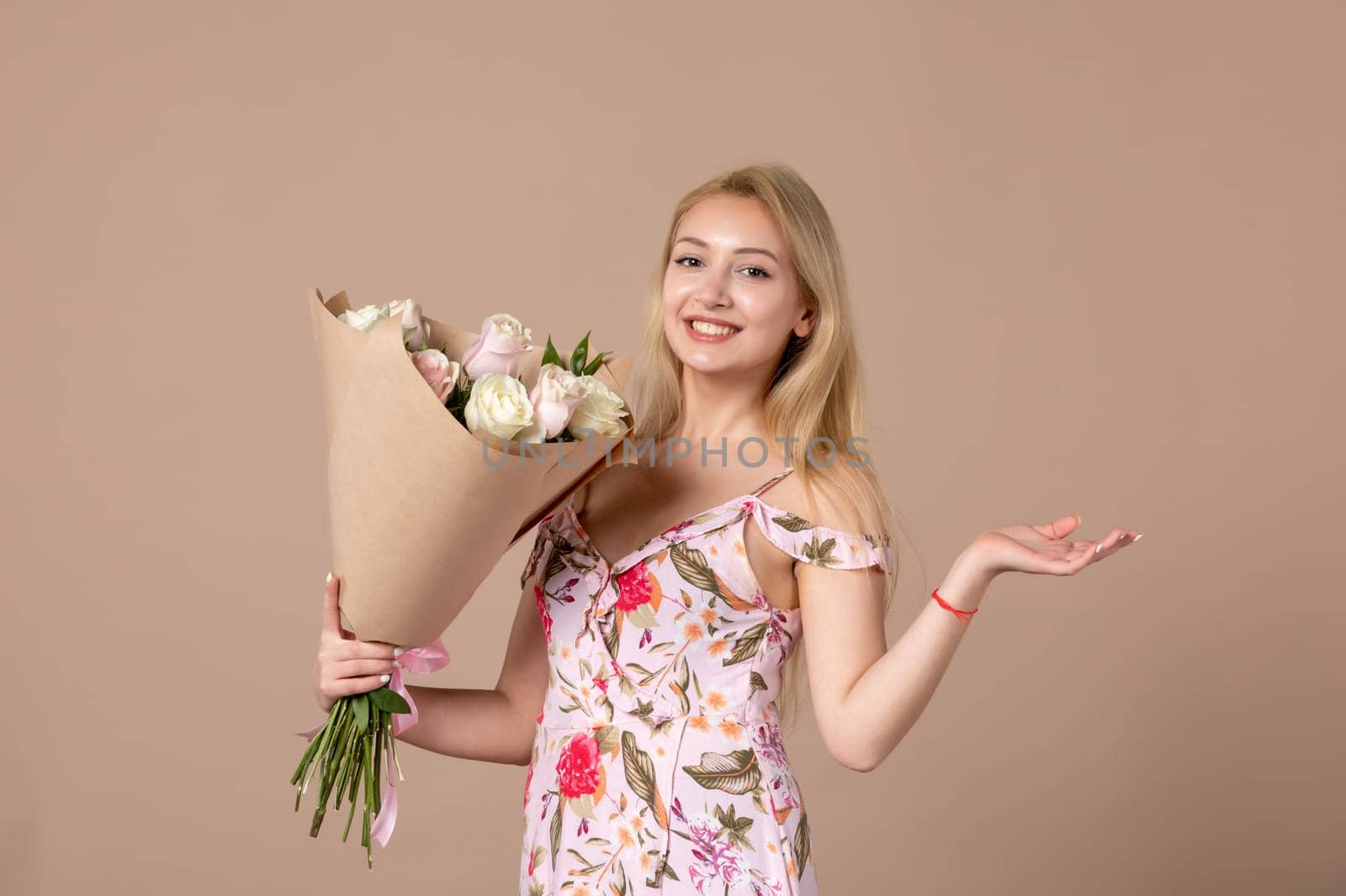 front view young female holding bouquet of beautiful roses on brown background feminine sensual woman horizontal march gift marriage equality