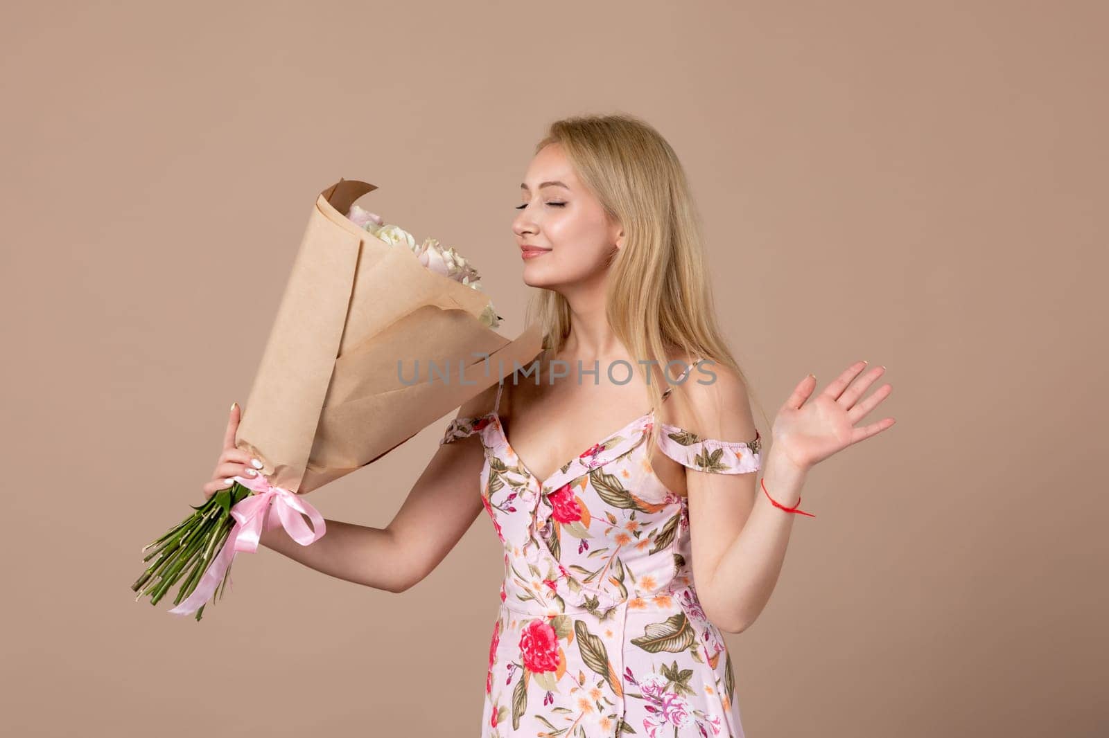 front view young female holding bouquet of beautiful roses on brown background feminine sensual woman horizontal march marriage equality