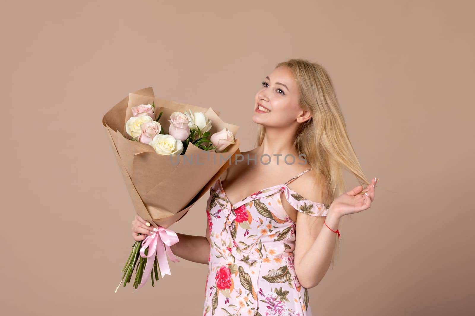 front view young female holding bouquet of beautiful roses on brown background sensual woman horizontal march gift marriage equality