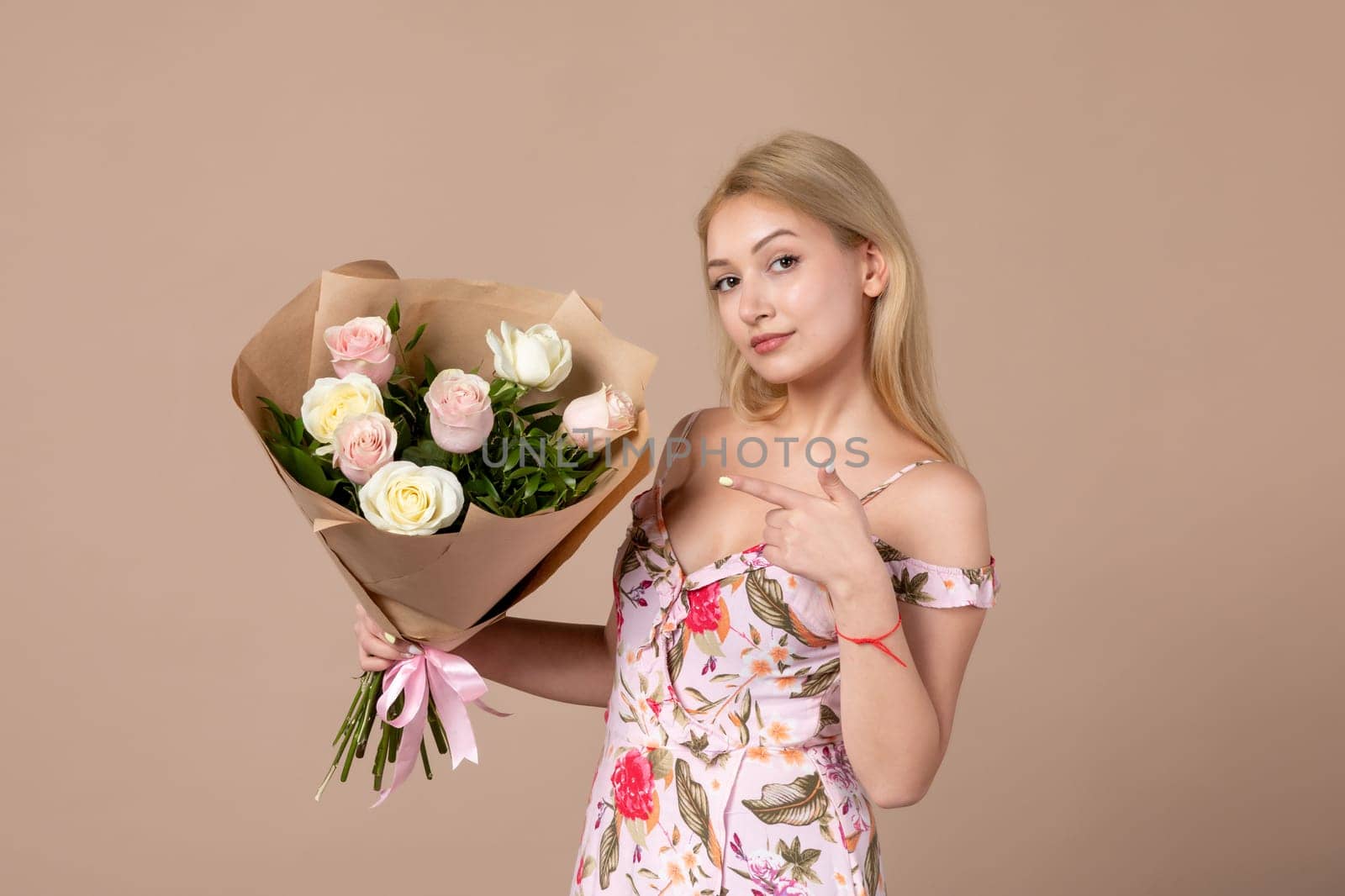 front view young female posing with bouquet of beautiful roses on brown background feminine sensual horizontal march gift equality woman