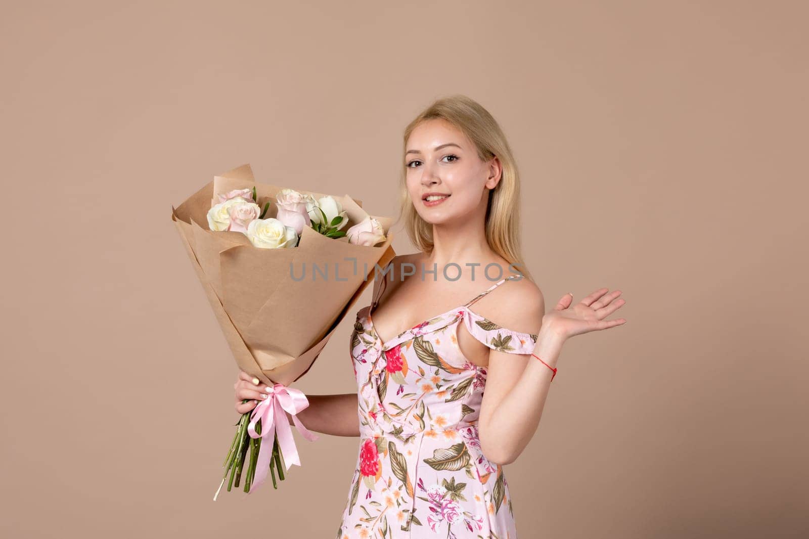 front view young female posing with bouquet of beautiful roses on brown background feminine sensual horizontal march gift marriage equality woman by Kamran