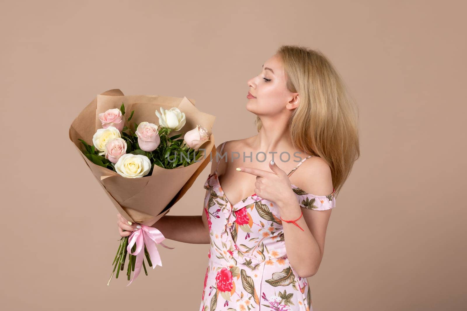 front view young female posing with bouquet of beautiful roses on brown background feminine sensual horizontal march marriage equality woman