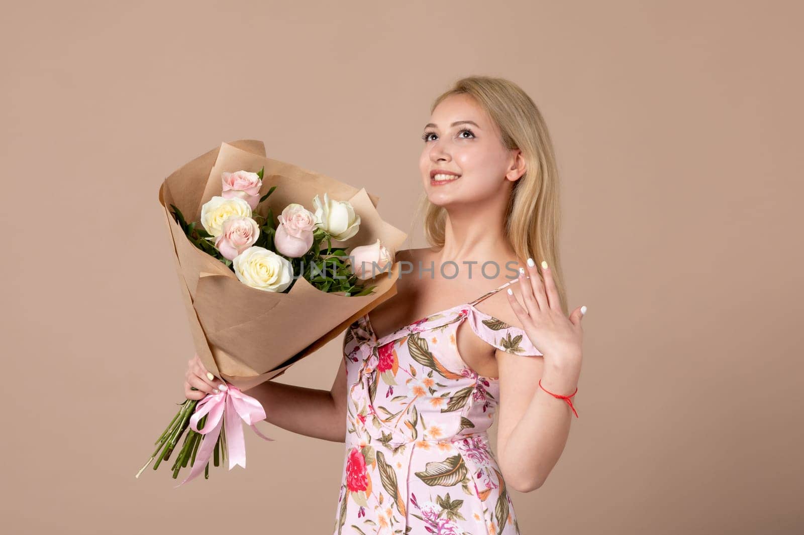front view young female posing with bouquet of beautiful roses on brown background feminine sensual horizontal march marriage equality woman gift by Kamran