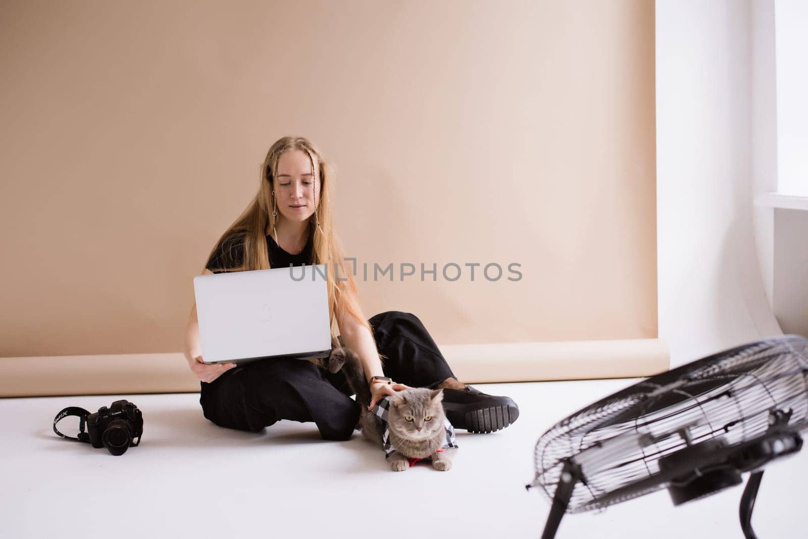 Woman freelancer working to MacBook with cat by OksanaFedorchuk