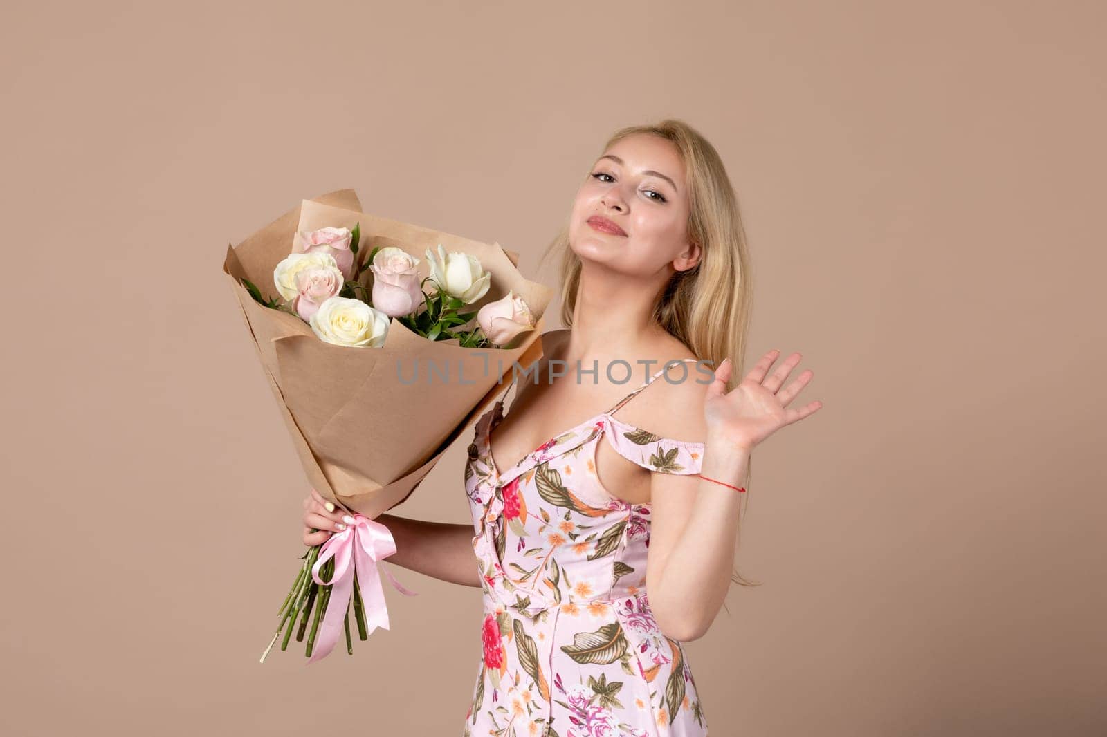 front view young female posing with bouquet of beautiful roses on brown background feminine sensual woman march gift marriage equality