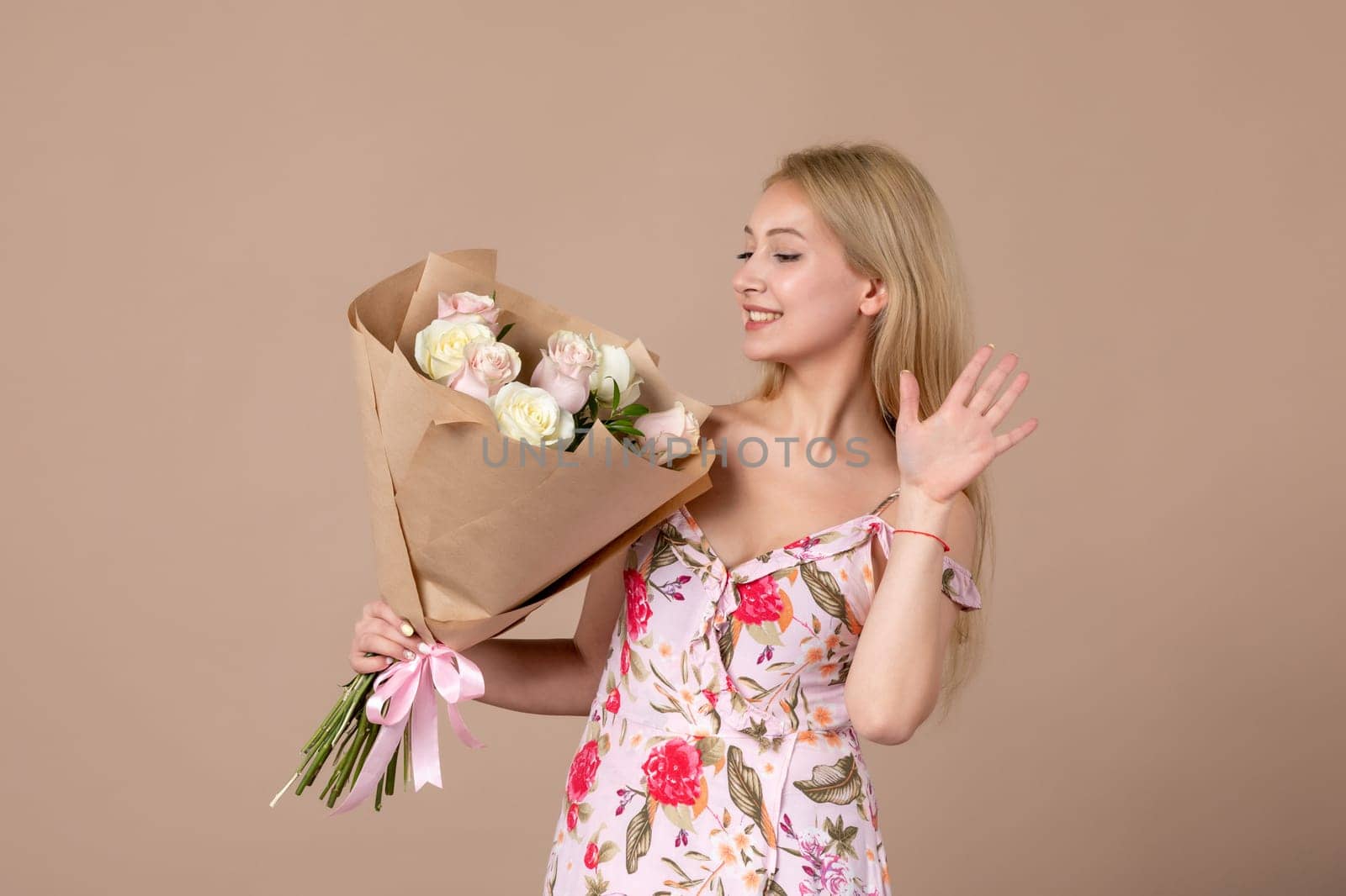 front view young female posing with bouquet of beautiful roses on brown background feminine sensual woman horizontal march gift marriage equality by Kamran