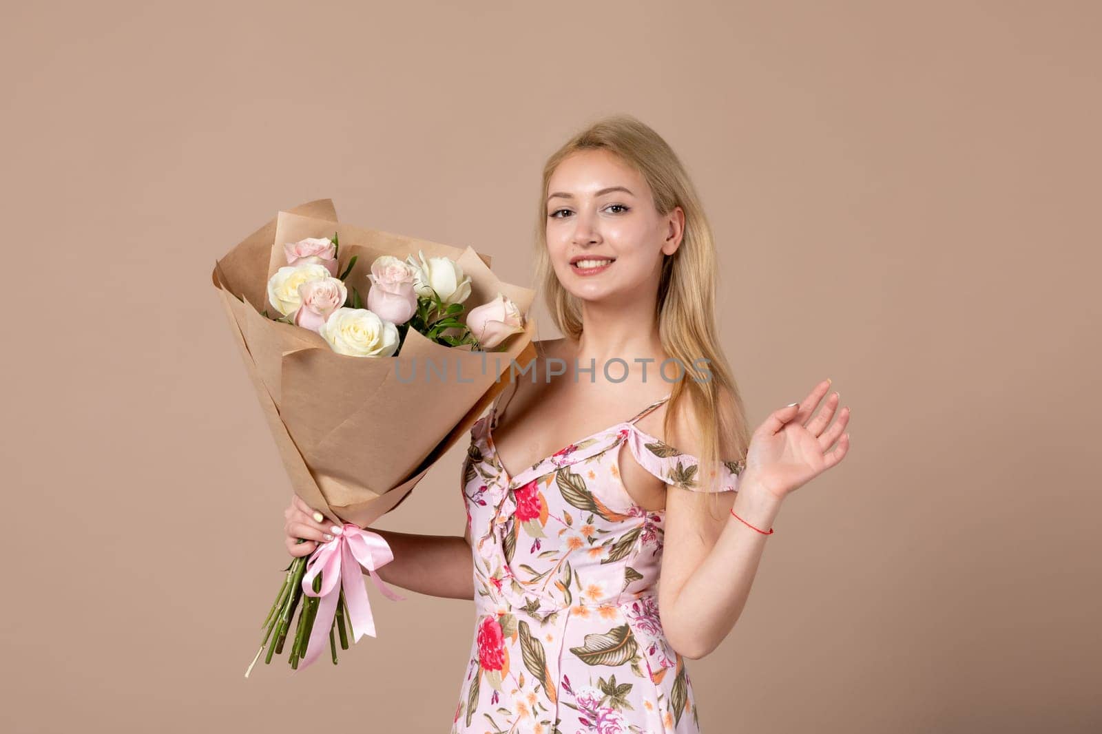 front view young female posing with bouquet of beautiful roses on brown background feminine sensual woman horizontal march marriage equality by Kamran