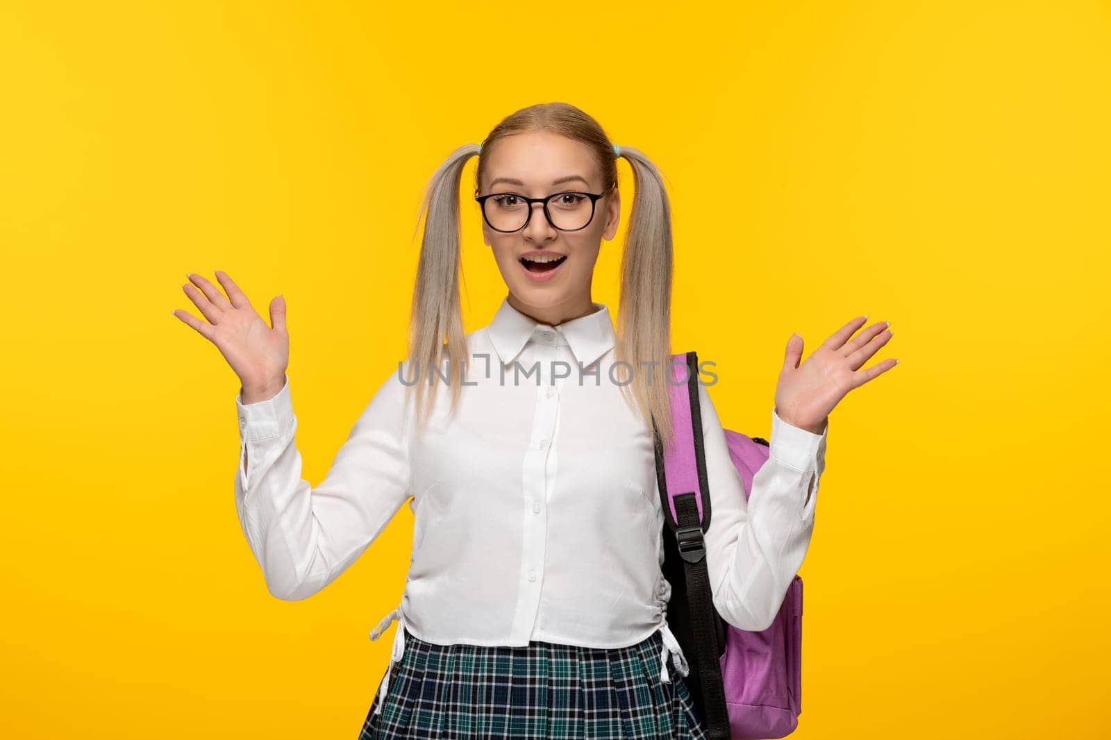 world book day blonde excited girl with backpack on yellow wallpaper with glasses by Kamran