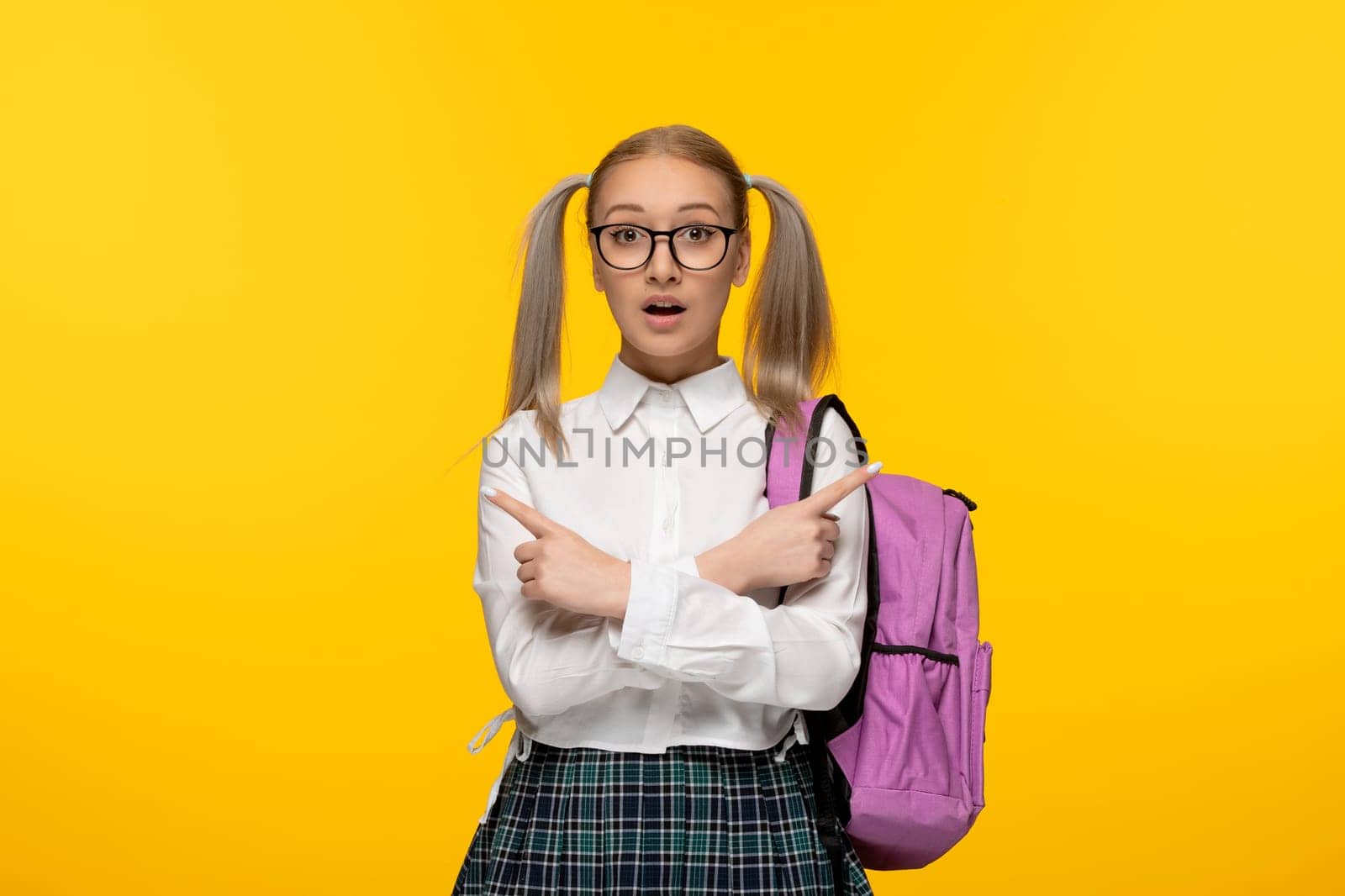 world book day blonde girl surprised in school uniform wearing glasses hands crossed