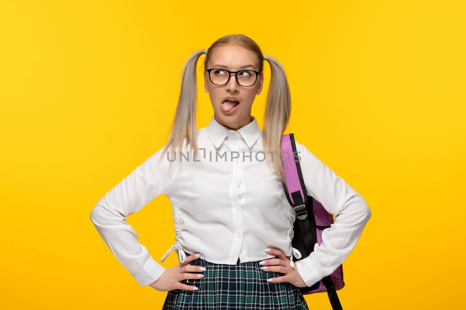 world book day blonde schoolgirl with tongue out in glasses on yellow background by Kamran