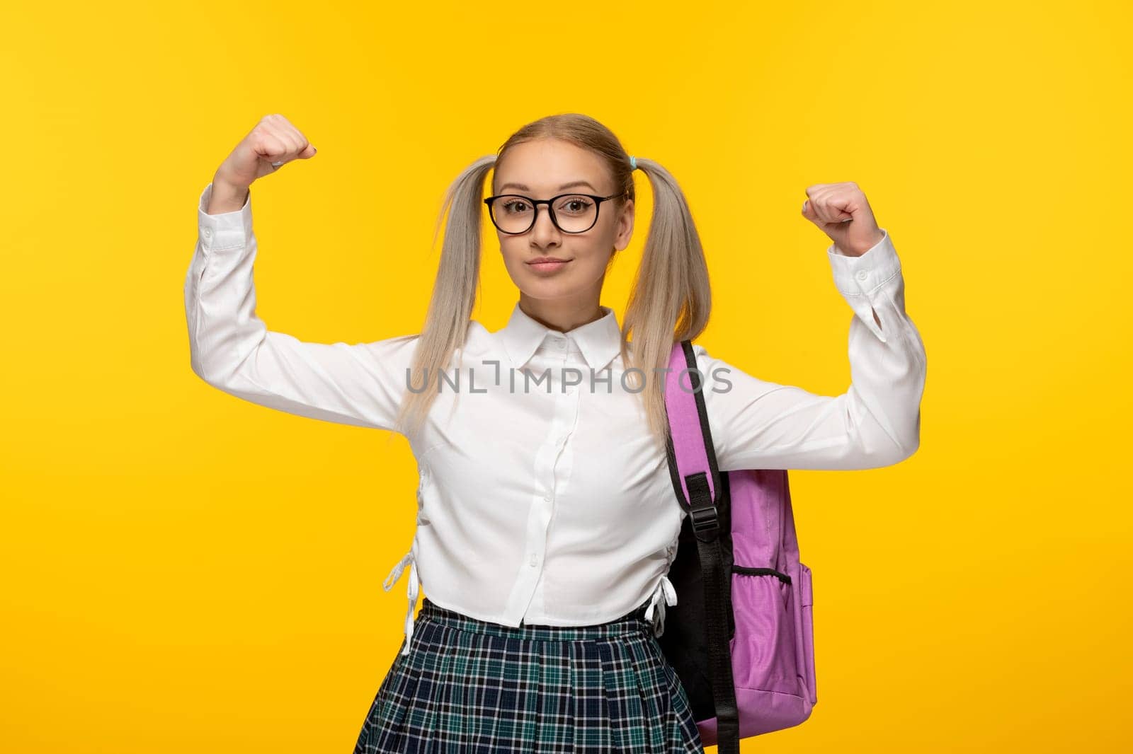 world book day blonde young girl with backpack in glasses showing muscles by Kamran