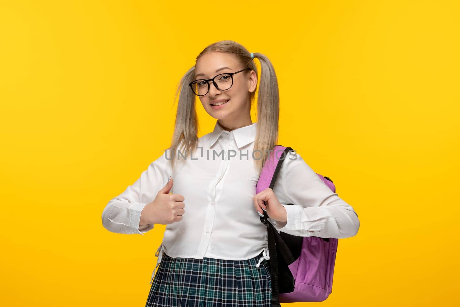 world book day blonde young schoolgirl ponytails with pink backpack by Kamran