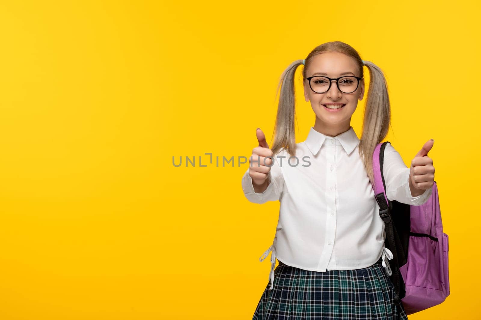 world book day cheerful school girl with pony tails showing great hand gesture