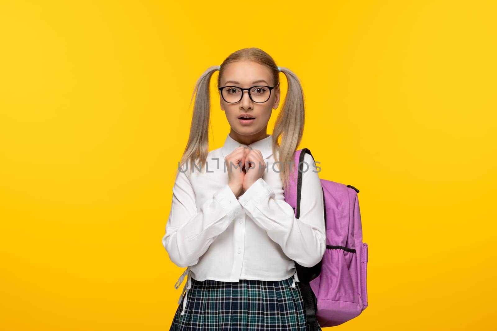 world book day excited school girl with pink backpack hands in heart shape by Kamran