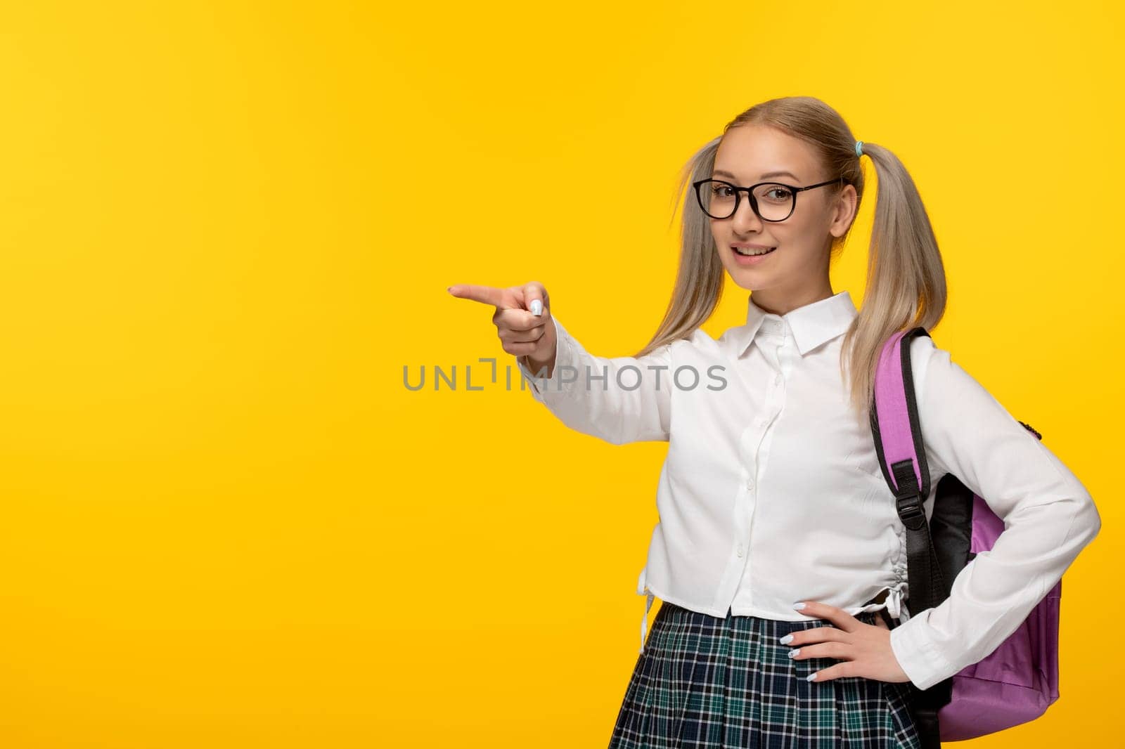 world book day funny happy schoolgirl pointing finger in school uniform