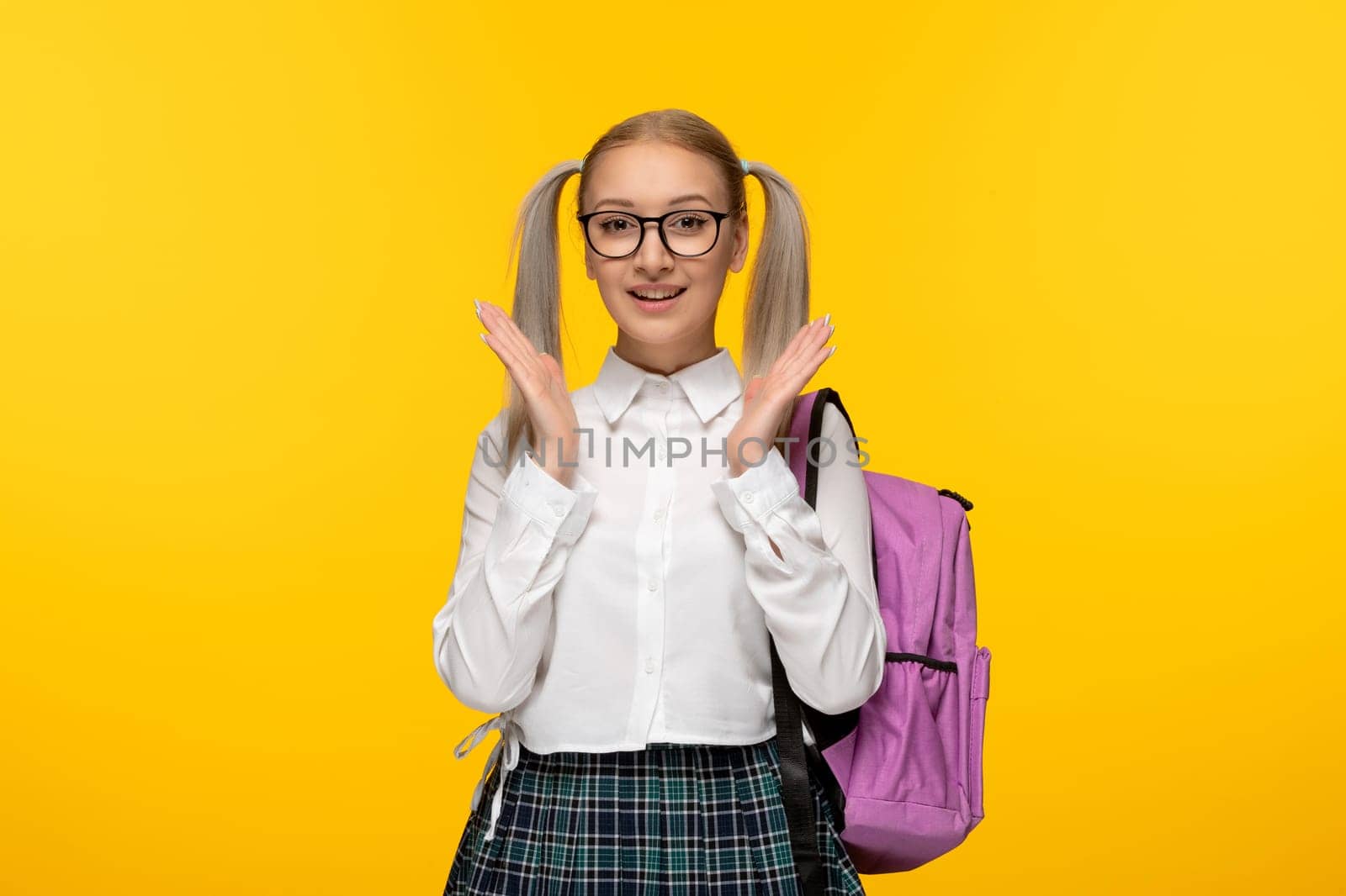 world book day happy blonde girl with waving hands and pink backpack