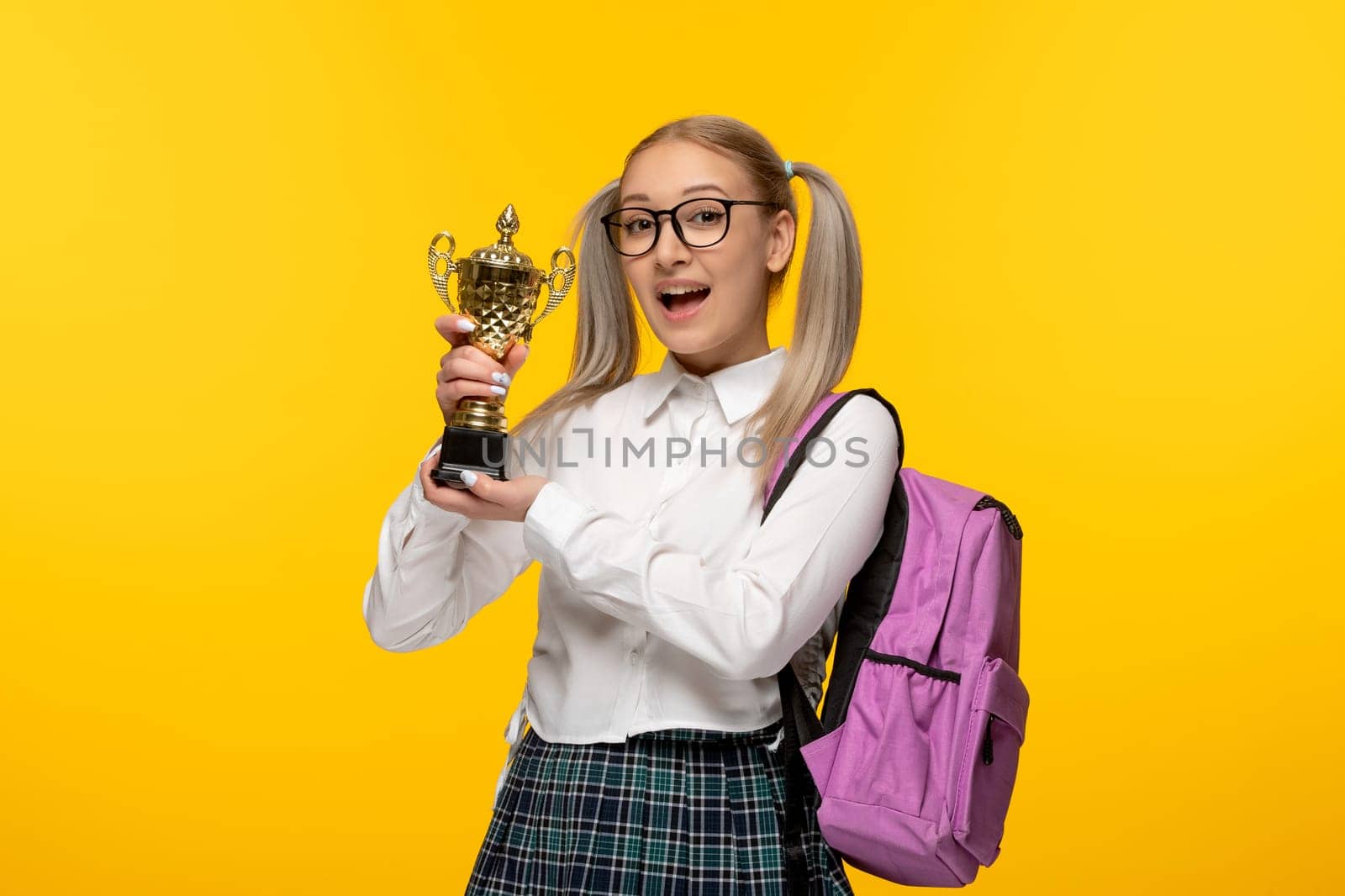 world book day happy school girl holding a price in glasses by Kamran
