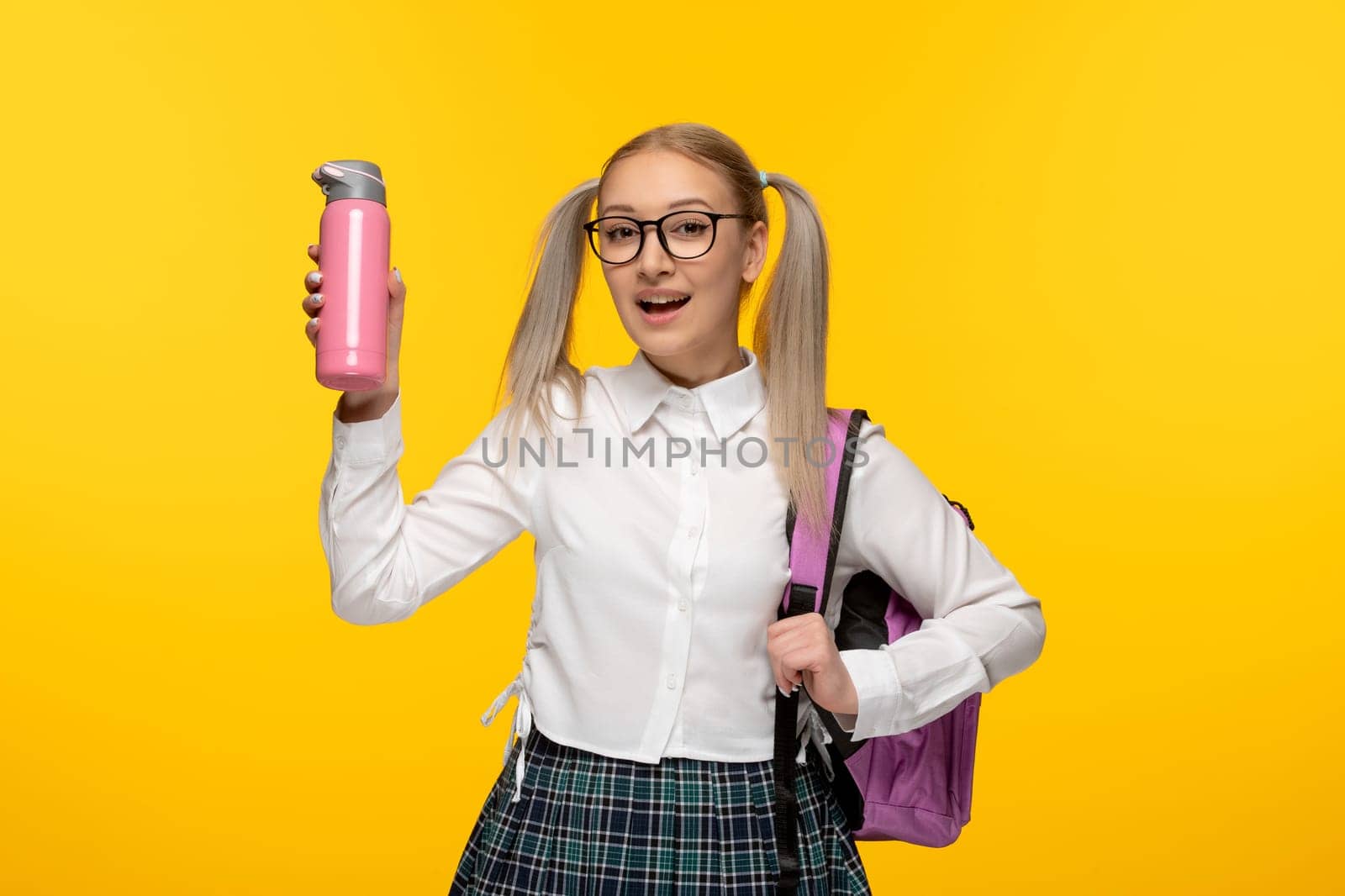 world book day happy schoolgirl in cute uniform with backpack and thermos by Kamran