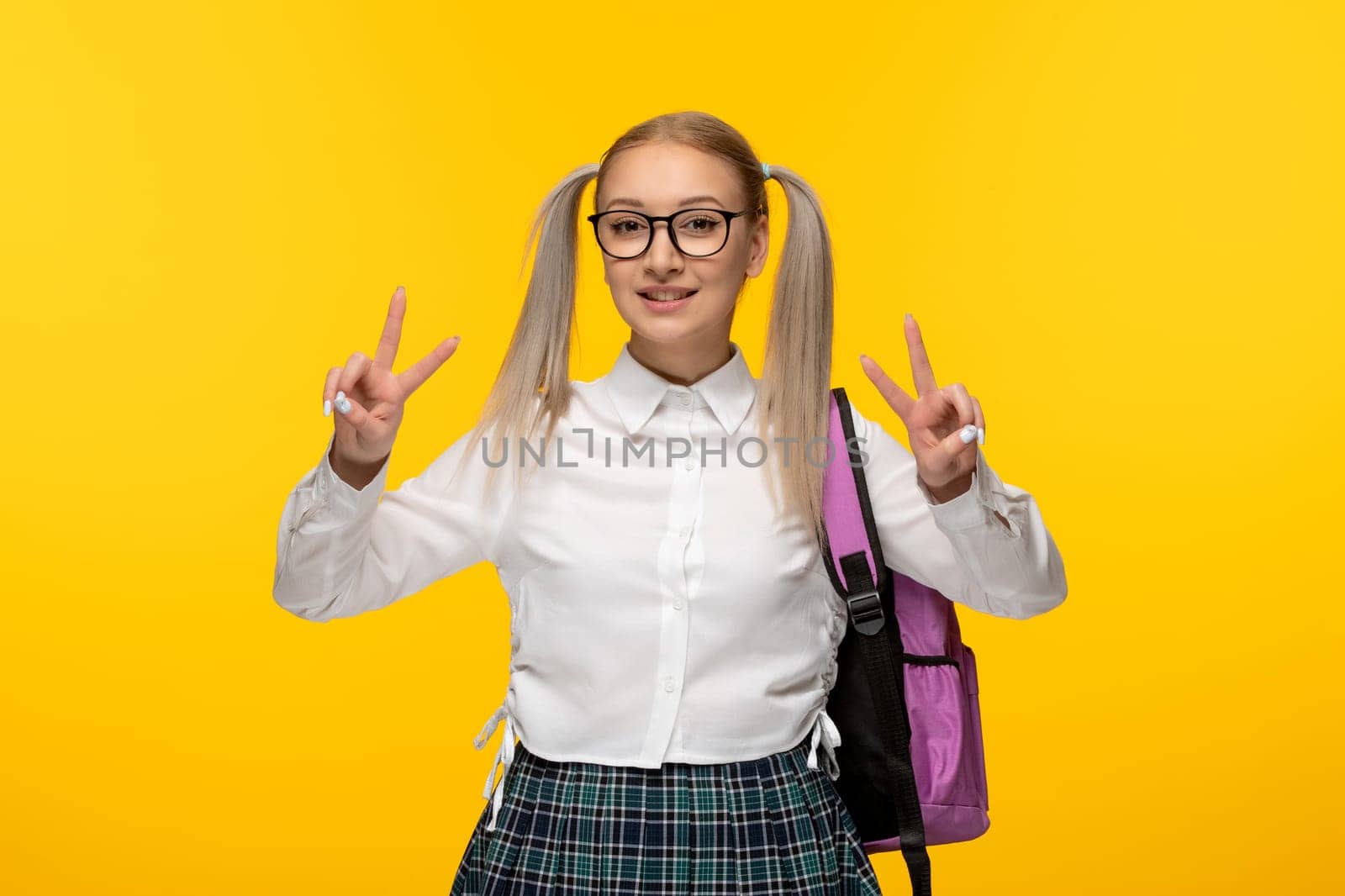 world book day happy smiling school girl showing peace gesture sign