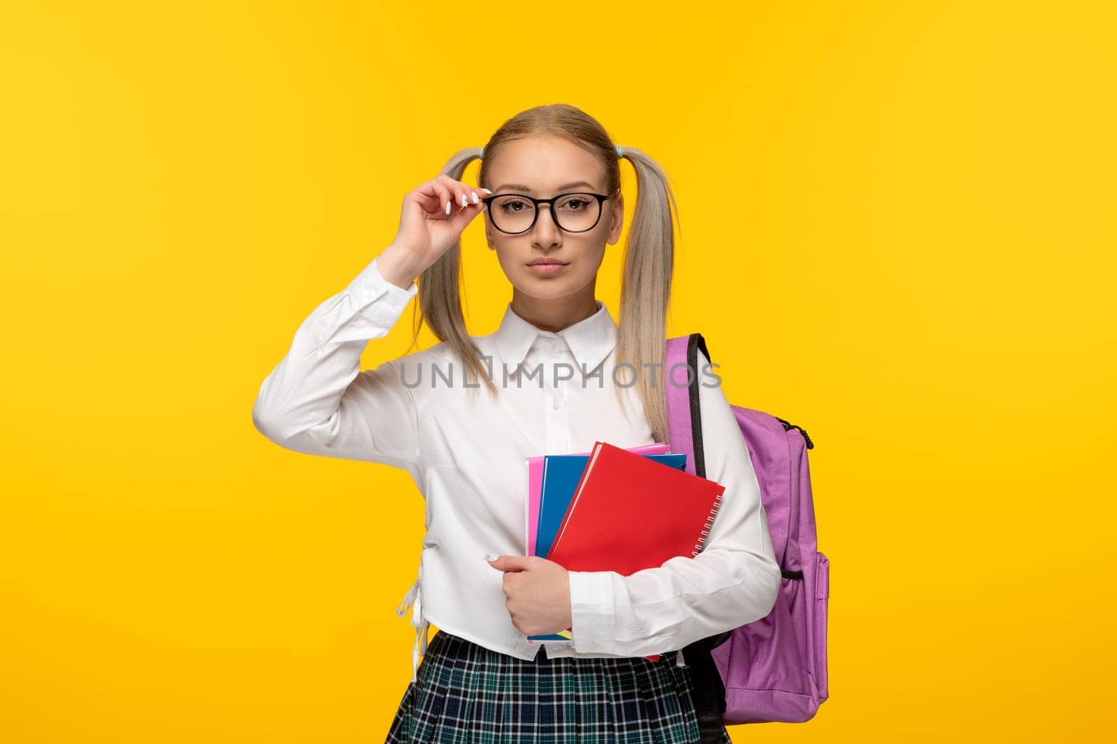 world book day serious blonde schoolgirl with pony tails wearing pink backpack and glasses by Kamran