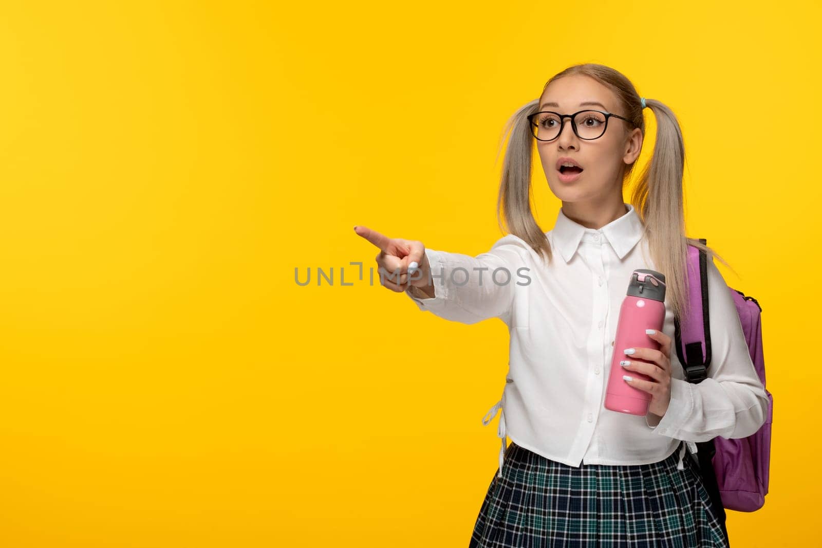 world book day shocked school girl with pink flask on yellow background by Kamran