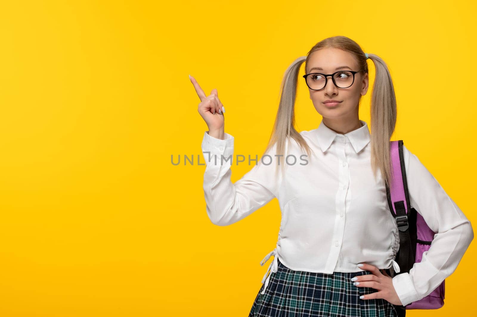 world book day smart blonde schoolgirl with ponytails pointing finger with pink backpack by Kamran