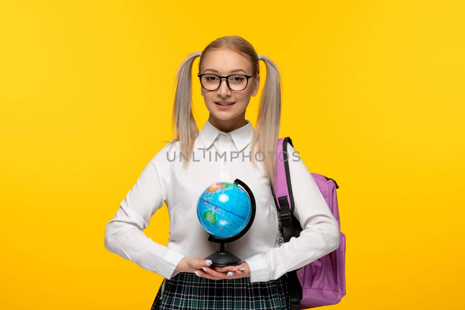 world book day smiling adorable school girl with backpack holding a globus by Kamran