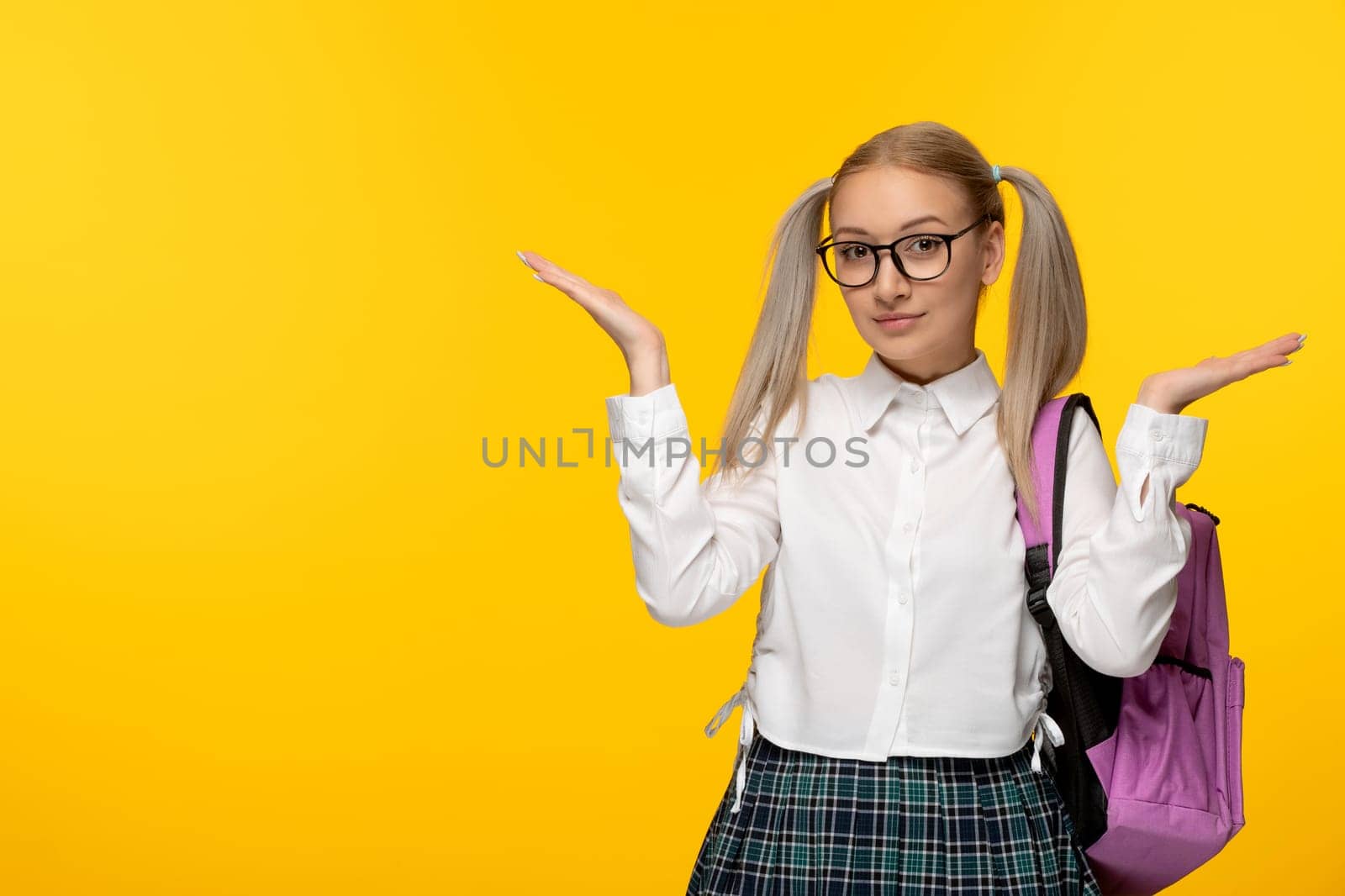 world book day smiling cute school girl waving hands and pink backpack