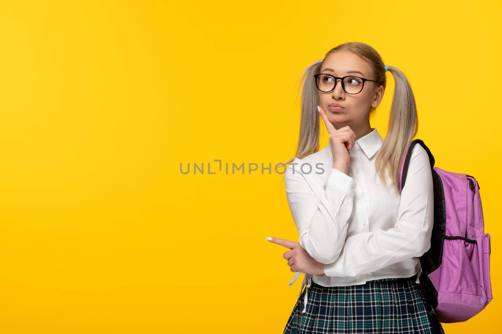 world book day thinking blonde student wearing glasses and a pink backpack