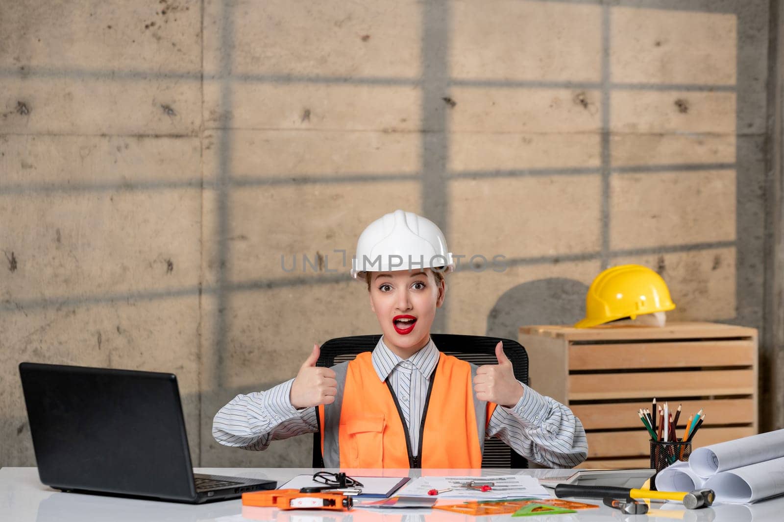 engineer cute young blonde smart girl civil worker in helmet and vest happy and cheerful