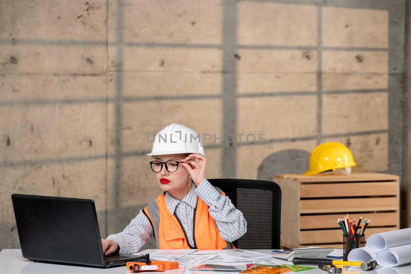 engineer cute young blonde smart girl civil worker in helmet and vest thinking focused by Kamran