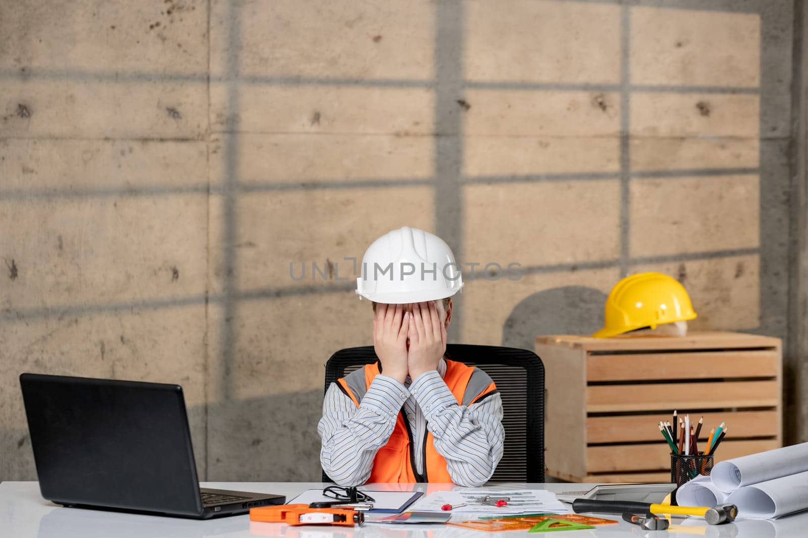 engineer smart young cute blonde girl civil worker in helmet and vest covering face by Kamran