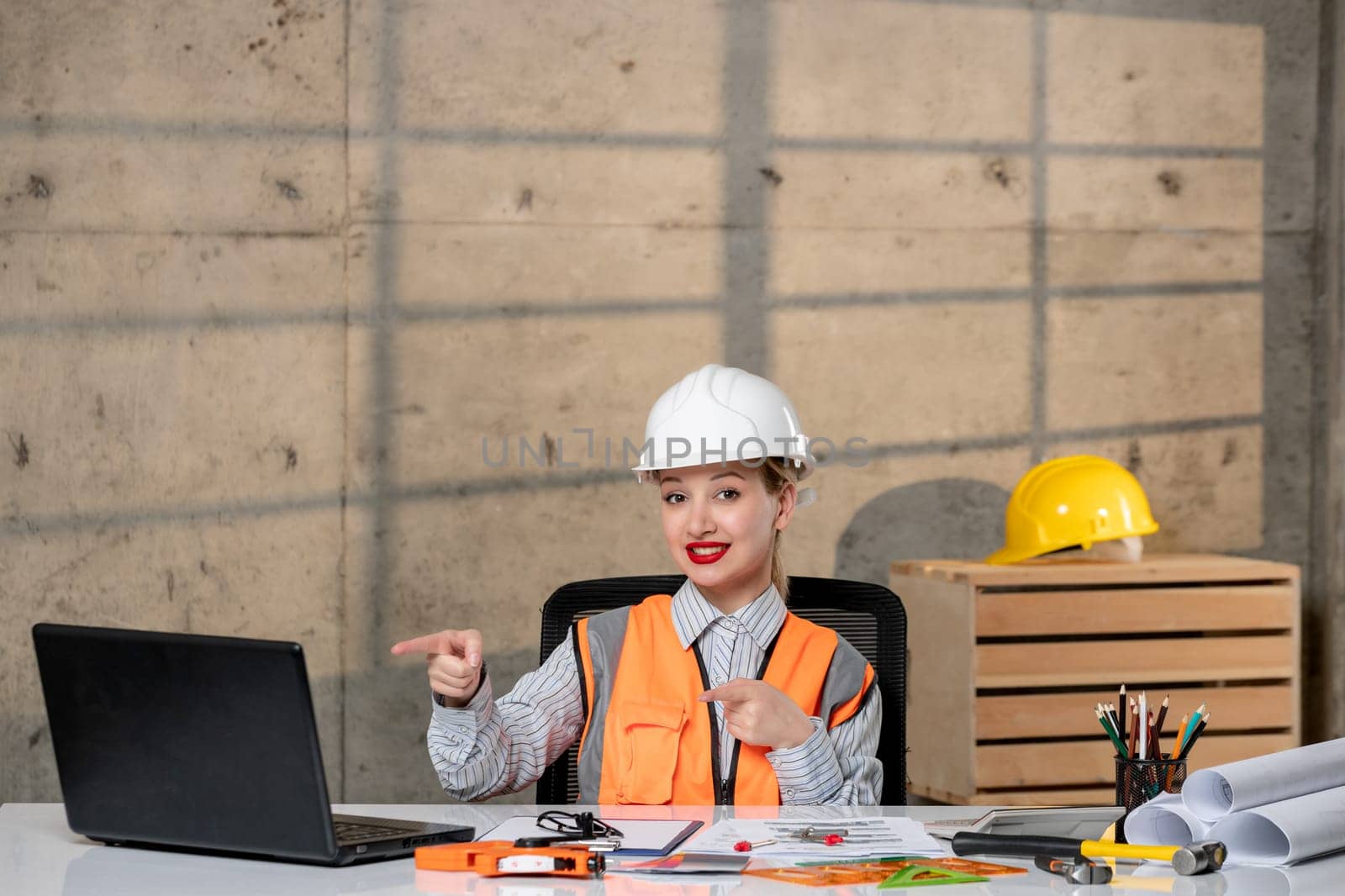 engineer smart young cute blonde girl civil worker in helmet and vest happy