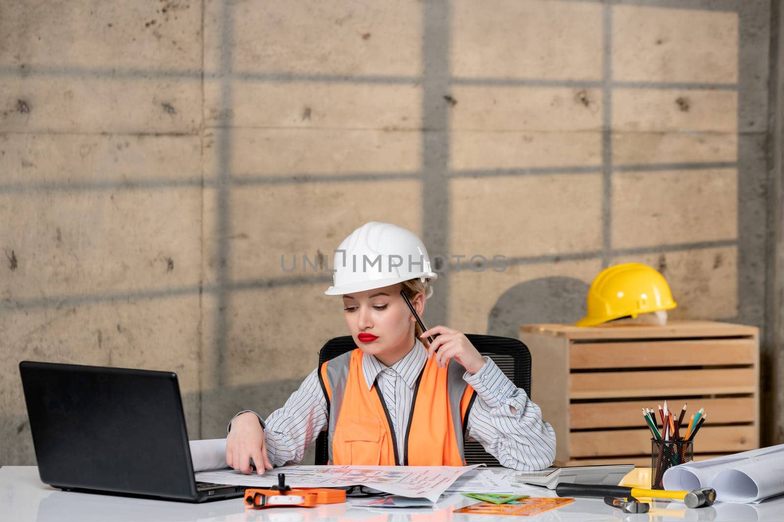 engineer smart young cute blonde girl civil worker in helmet and vest thinking of building