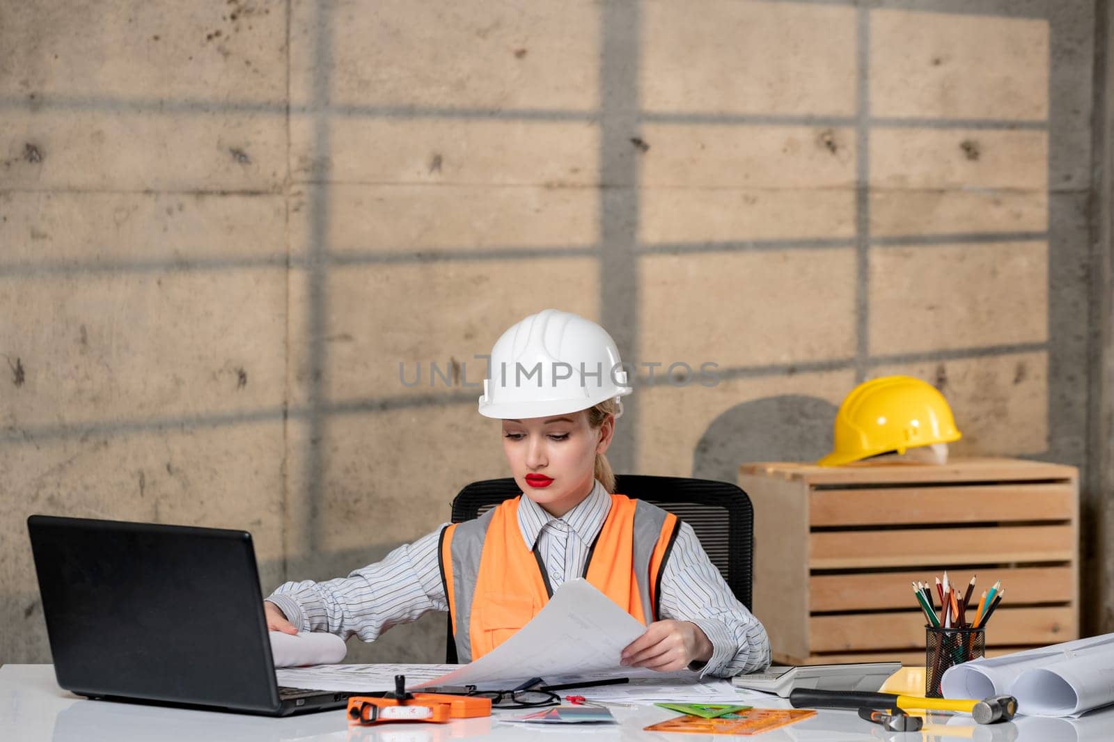engineer smart young cute blonde girl civil worker in helmet and vest with new building plan by Kamran