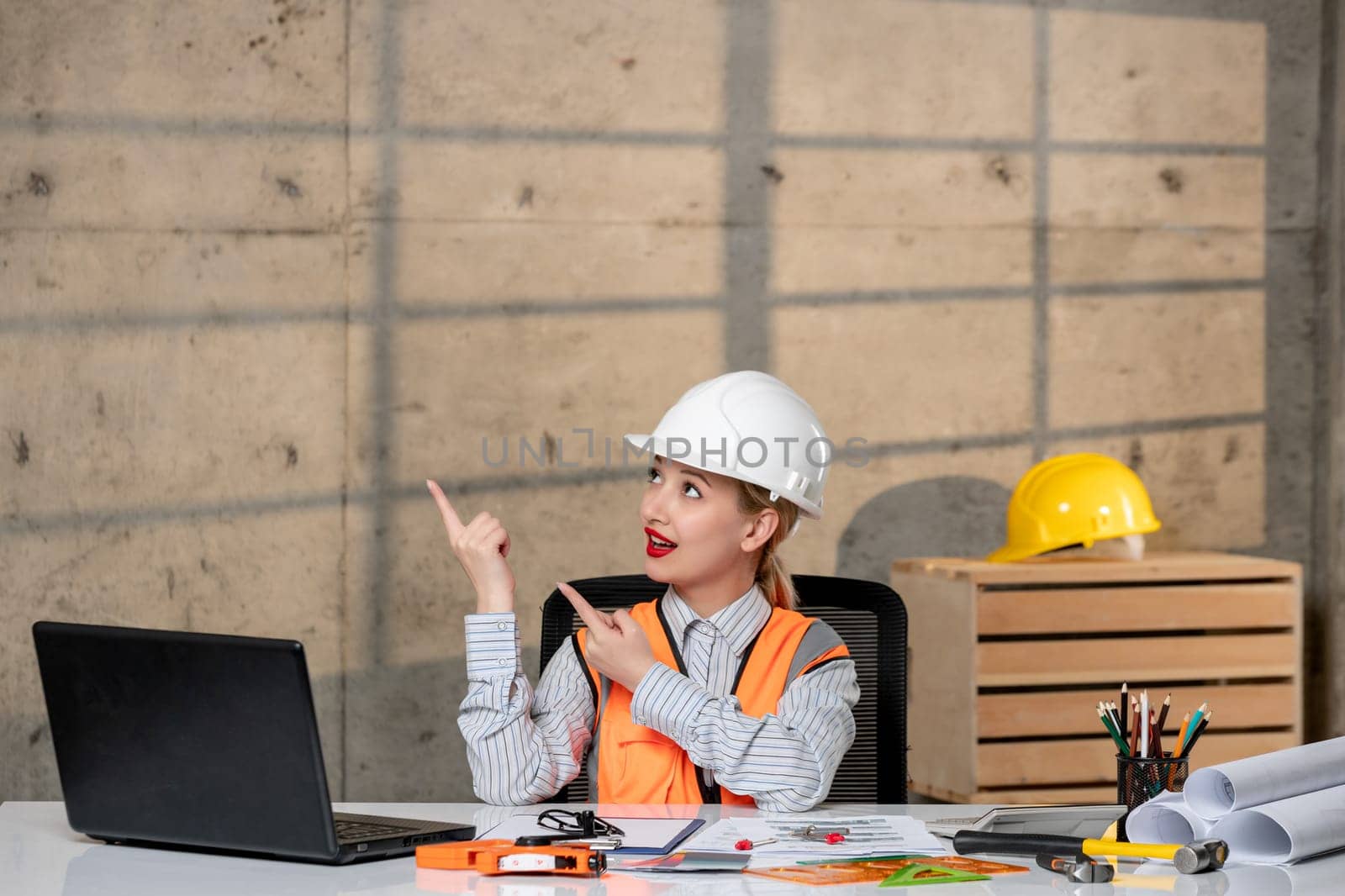engineer young smart cute blonde girl civil worker in helmet and vest having an idea about plan by Kamran