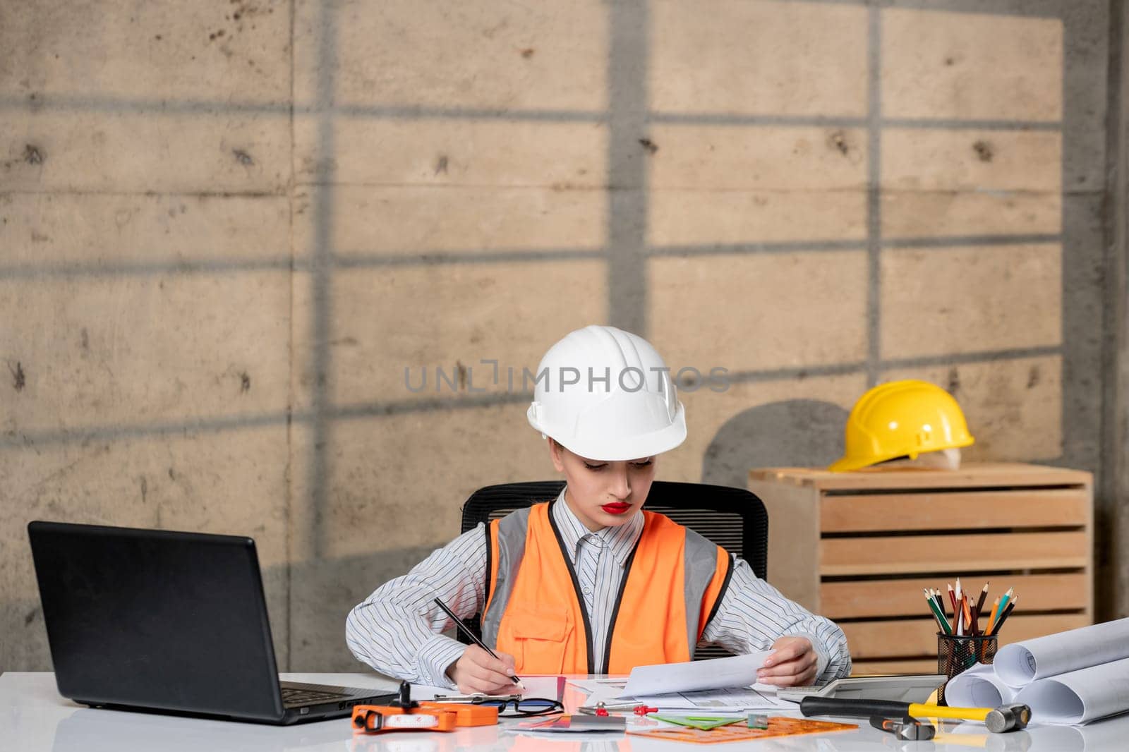 engineer young smart cute blonde girl civil worker in helmet and vest working