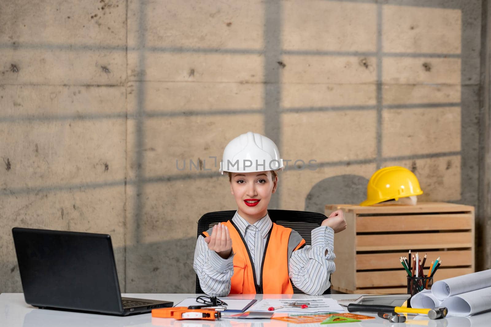engineer in helmet and vest civil worker smart young cute blonde girl inviting over